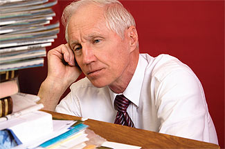 man staring at overflowing inbox